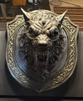 Front view of Dogman bust in ornate shield-shaped frame