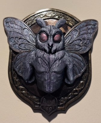 Mothman wall plaque displayed on a wall