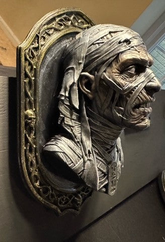 Angled view of Mummy bust showing sculpted wrappings