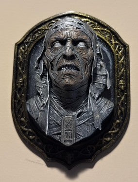 Mummy bust wall plaque displayed on a wall