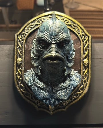 Front view of ornate lagoon-creature plaque