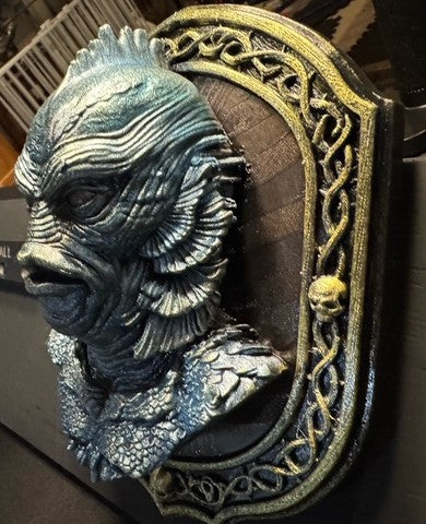 Angled detail of lagoon-creature plaque