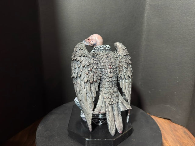 Rear view of The Ossuary Rose vulture statue with wings spread