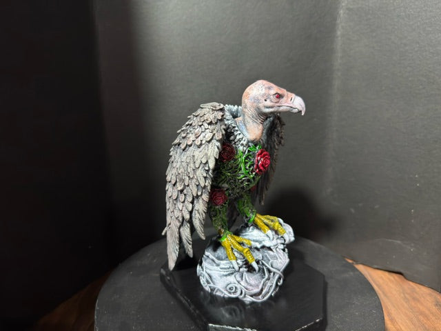 Three-quarter view of The Ossuary Rose vulture statue on stone base
