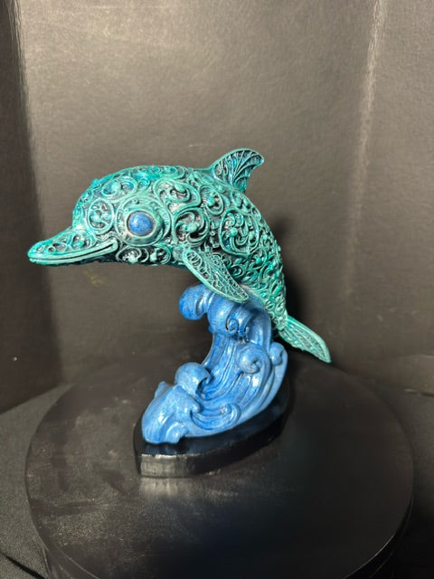 Filigree dolphin statue three-quarter view — full filigree body and wave plinth