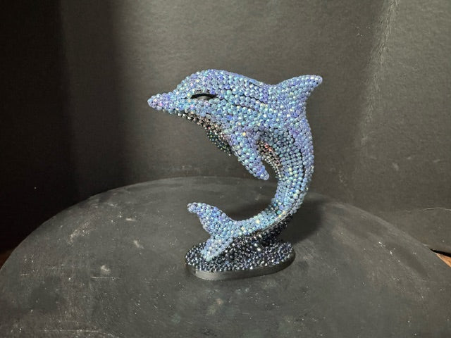 Full front view of Celestial Tide dolphin statue on oval base