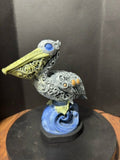 Ornate hand-painted pelican statue front view
