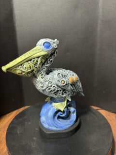 Ornate hand-painted pelican statue front view