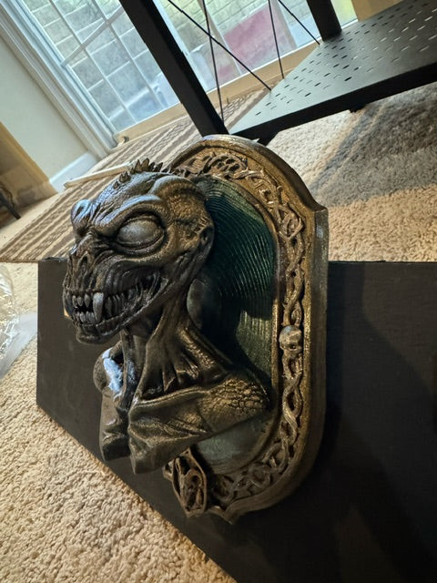 Angled view showing the sculptural depth of the Chupacabra cryptid relief