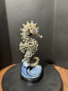 Ornate hand-painted seahorse statue side view