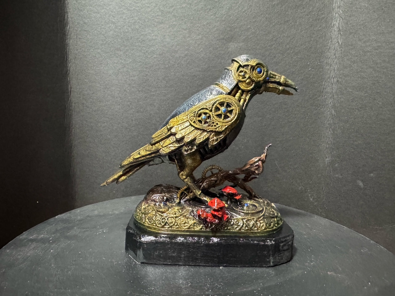 Forest Guardian Crow - side view showing gold filigree wings and blue sapphire eye